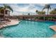 Bright outdoor pool area featuring lounge chairs and a covered patio with lush landscaping at 5735 E Mcdowell Rd # 63, Mesa, AZ 85215