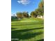 Serene putting green surrounded by lush greenery, offering a tranquil space for leisure and recreation at 5735 E Mcdowell Rd # 63, Mesa, AZ 85215