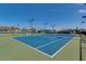 Well-maintained tennis court, a fun recreation space for residents, with clear blue skies above at 5735 E Mcdowell Rd # 63, Mesa, AZ 85215