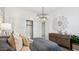 Bedroom with a decorative floral mirror, chandelier and a sliding door closet at 5845 E Axle Ln, San Tan Valley, AZ 85140