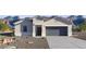 Charming single-story home featuring a two-car garage, desert landscaping, and a neutral color palette at 5845 E Axle Ln, San Tan Valley, AZ 85140