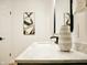 Bright bathroom with white marble countertop, black fixtures, white sink, and decorative vase at 6401 E Eugie Ter, Scottsdale, AZ 85254