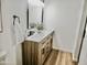 Modern bathroom vanity with double sinks, marble countertop, wood cabinetry, and matte black fixtures at 6401 E Eugie Ter, Scottsdale, AZ 85254