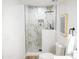Stylish bathroom showcases a toilet and luxurious glass shower with marble-patterned tile and black shower head at 6401 E Eugie Ter, Scottsdale, AZ 85254