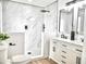 Modern bathroom features a double sink vanity, marble counters, and a frameless walk-in shower at 6401 E Eugie Ter, Scottsdale, AZ 85254