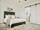 The bedroom features a bed with a decorative rug and a barn door to the bathroom at 6401 E Eugie Ter, Scottsdale, AZ 85254