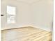Bright bedroom featuring wood-look flooring, white walls, and a window view of the neighborhood at 6401 E Eugie Ter, Scottsdale, AZ 85254