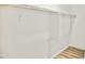 A clean, bright closet features wood laminate flooring and ample hanging space at 6401 E Eugie Ter, Scottsdale, AZ 85254