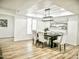 Bright dining room with stylish lighting, wood floors, and comfortable upholstered seating at 6401 E Eugie Ter, Scottsdale, AZ 85254