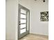Modern entryway featuring a gray front door with glass panels and a stylish interior at 6401 E Eugie Ter, Scottsdale, AZ 85254