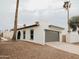 Exterior view of the home showcasing a garage and desert landscaping at 6401 E Eugie Ter, Scottsdale, AZ 85254