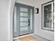 Close-up of the modern gray front door with glass panels and stylish hardware at 6401 E Eugie Ter, Scottsdale, AZ 85254
