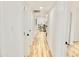 Bright hallway with doors and modern light-colored wood-look floors at 6401 E Eugie Ter, Scottsdale, AZ 85254