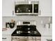 Modern kitchen with a stainless steel range and sleek white countertops at 6401 E Eugie Ter, Scottsdale, AZ 85254