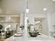 Open-concept kitchen island with modern pendant lighting and bar seating that merges into the living space at 6401 E Eugie Ter, Scottsdale, AZ 85254