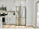 Modern kitchen featuring stainless steel refrigerator and white shaker cabinets at 6401 E Eugie Ter, Scottsdale, AZ 85254