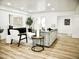 Open concept living room with wood floors, a stylish grey sofa, and contemporary furnishings at 6401 E Eugie Ter, Scottsdale, AZ 85254