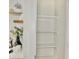 Pantry featuring ample shelving for organized storage and a decorative open shelves next to pantry at 6401 E Eugie Ter, Scottsdale, AZ 85254