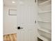 Bright pantry with multiple shelves and a modern white door with black handle at 6401 E Eugie Ter, Scottsdale, AZ 85254