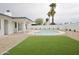 Backyard oasis featuring a kidney shaped pool, green space, and a pristine privacy wall at 6401 E Eugie Ter, Scottsdale, AZ 85254