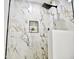 Close-up of the marble-patterned shower with modern fixtures and built-in shelving niche at 6401 E Eugie Ter, Scottsdale, AZ 85254