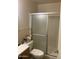 Classic bathroom with a glass-enclosed shower and convenient storage above the toilet for everyday essentials at 8307 W Indianola Ave, Phoenix, AZ 85037