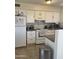 Bright kitchen with white appliances and cabinetry offers plenty of counter space at 8307 W Indianola Ave, Phoenix, AZ 85037