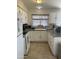 Bright kitchen features white appliances and cabinetry with plenty of counter space at 8307 W Indianola Ave, Phoenix, AZ 85037