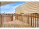 Exterior shot of a home featuring a wood deck, metal siding, and a clear sky in a sunny outdoor setting at 853 S Evangeline Ave, Mesa, AZ 85208