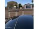 View of home from car sunroof, showing gated yard with metal awning for parking and small shed at 853 S Evangeline Ave, Mesa, AZ 85208