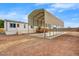 Manufactured home featuring a large carport and low maintenance landscaping in a desert climate at 853 S Evangeline Ave, Mesa, AZ 85208