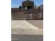 View of home's gated yard with metal awning for parking and sidewalk leading up to the gate at 853 S Evangeline Ave, Mesa, AZ 85208