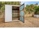 View of an opened shed featuring concrete flooring and metal walls at 853 S Evangeline Ave, Mesa, AZ 85208