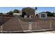 Gated yard of home with metal awning for parking, shed, and view of the home with desert landscaping at 853 S Evangeline Ave, Mesa, AZ 85208