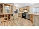 Charming kitchen with light wood cabinetry, stainless steel appliances, and modern flooring for a comfortable cooking space at 853 S Evangeline Ave, Mesa, AZ 85208