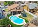 Aerial view of a backyard featuring a pristine pool, patio, manicured lawn, and trampoline in a fully fenced yard at 8912 W Sheridan St, Phoenix, AZ 85037