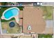 Aerial view of a single-Gathering home, showcasing the pool, trampoline, and updated roof at 8912 W Sheridan St, Phoenix, AZ 85037