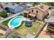 Aerial view of backyard with a pool and trampoline at 8912 W Sheridan St, Phoenix, AZ 85037