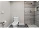This updated bathroom has a stylish tiled shower with pebble accents and modern fixtures at 8912 W Sheridan St, Phoenix, AZ 85037