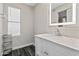 Bathroom featuring a white vanity with marble countertop, a modern sink and a large mirror at 8912 W Sheridan St, Phoenix, AZ 85037