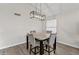 Dining room features a modern light fixture and table with four chairs, perfect for hosting at 8912 W Sheridan St, Phoenix, AZ 85037