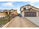 Street view of a two-story home with a big driveway and well-maintained lawn at 8912 W Sheridan St, Phoenix, AZ 85037