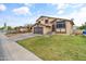 Charming two-story home with a well-maintained front lawn and attached two-car garage at 8912 W Sheridan St, Phoenix, AZ 85037