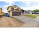 Front view of a well-maintained two story house with a long driveway at 8912 W Sheridan St, Phoenix, AZ 85037