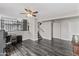 Open living room with dark wood floors, ceiling fan and stairs to the second level at 8912 W Sheridan St, Phoenix, AZ 85037