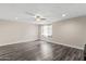 Large bonus room featuring a ceiling fan, light walls, and wood-look flooring at 8912 W Sheridan St, Phoenix, AZ 85037