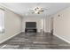 Spacious living room with a ceiling fan, wood-look floors, and a large screen TV and cabinet at 8912 W Sheridan St, Phoenix, AZ 85037