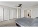 Large main bedroom with carpet, ceiling fan, a large closet, and ensuite bathroom access at 8912 W Sheridan St, Phoenix, AZ 85037
