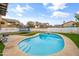Beautiful backyard pool surrounded by a concrete deck and synthetic grass at 8912 W Sheridan St, Phoenix, AZ 85037