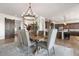 Well lit dining room with open floor plan, chandelier and sliding barn door at 11249 N Blakely St, Surprise, AZ 85388